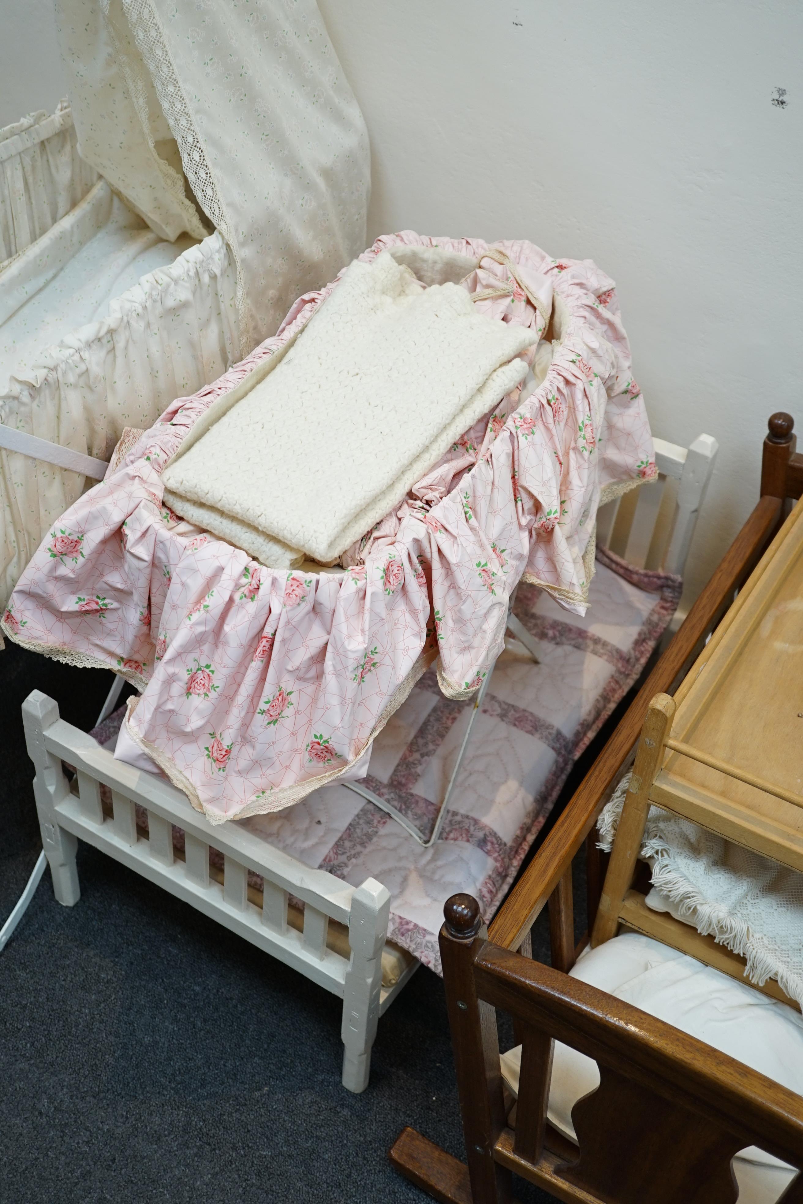 A collection of nine doll’s cribs of wood or wrought iron construction, together with two nineteenth century style doll’s ’bath chairs’, a toy mangle, Disney themed Snow White carpet sweeper and a boxed child’s sewing ma